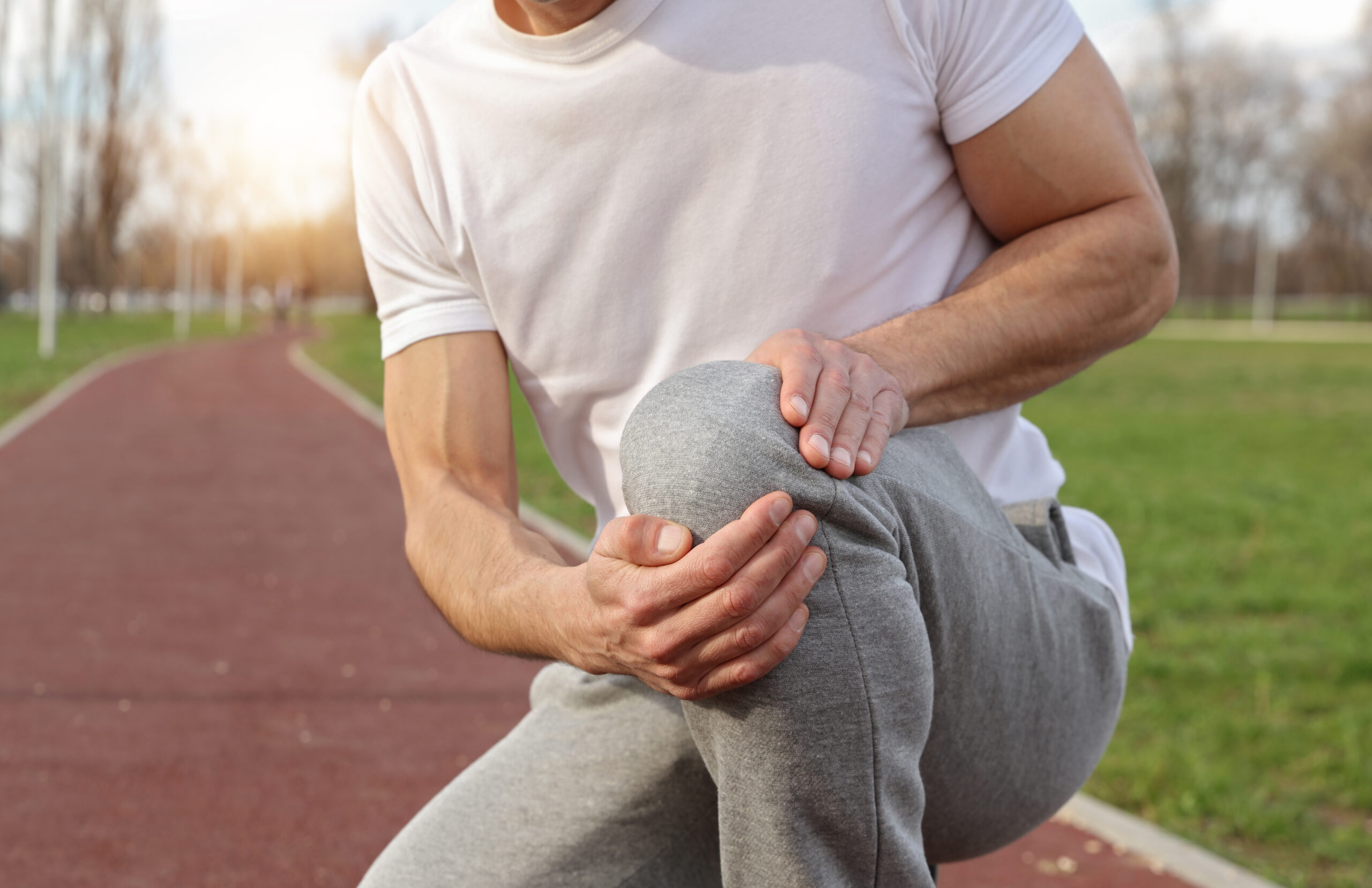 Sport injury, Man runner with knee pain. Pain relief and health care concept.